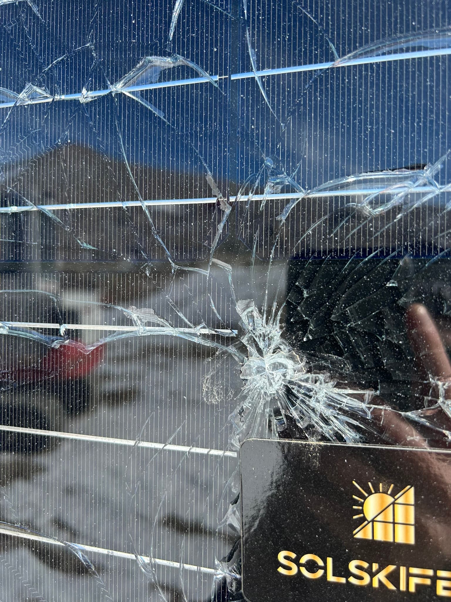 Shattered front glass with mountains reflected in the surface